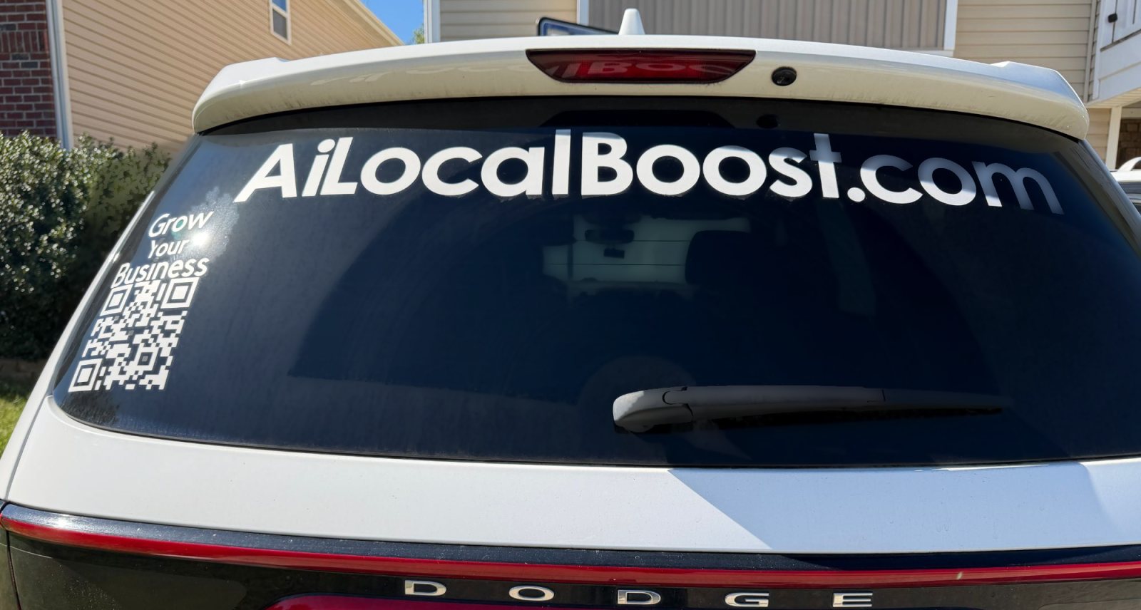 The AI Local Boost SUV with AiLocalBoost.com on the rear window